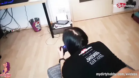 She's playing on the console and her boyfriend is fucking her from behind!